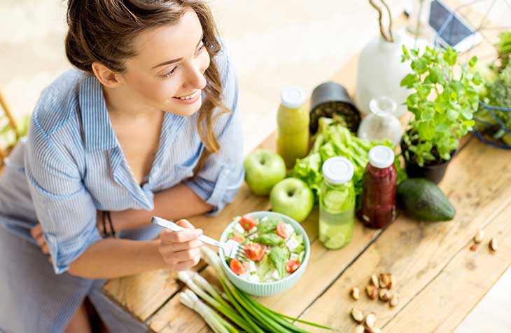 A Woman Eating Well After Exercise To Highlight The Physical Benefits Treatment Has For Addiction Recovery