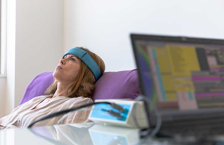 A Woman Receiving Biofeedback A Form Of Experiential Therapy