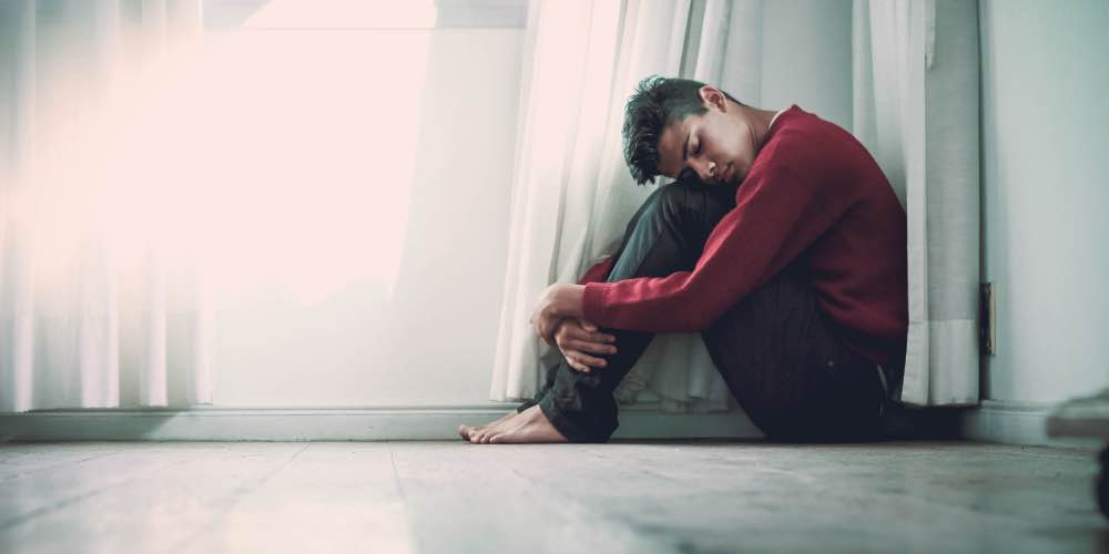 Man On Floor Struggling With Depression And Addiction