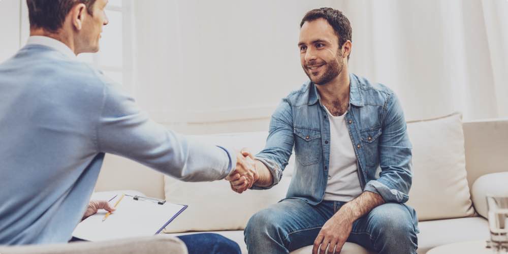 Client Shaking Hands With Therapist To Symbolize The Need For Licenses And Accredidation When Finding The Best Opioid Rehab Center