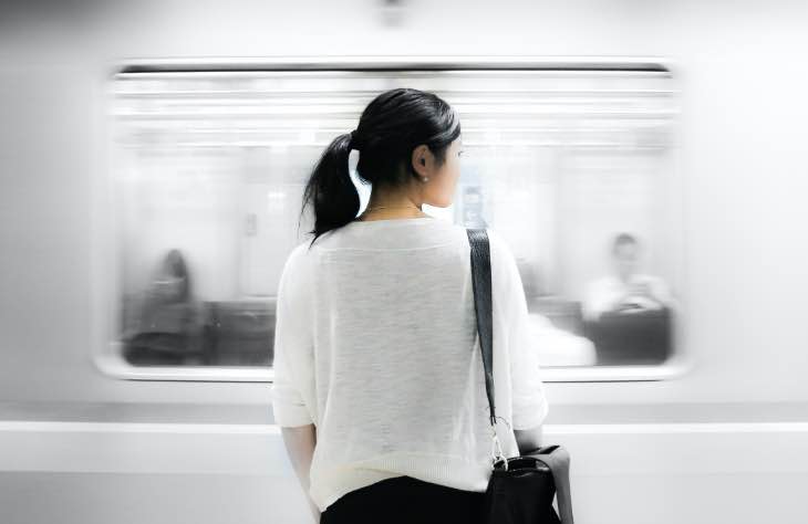 Woman Looking At Passing Bus As She Contemplates Her Alcohol Addiction