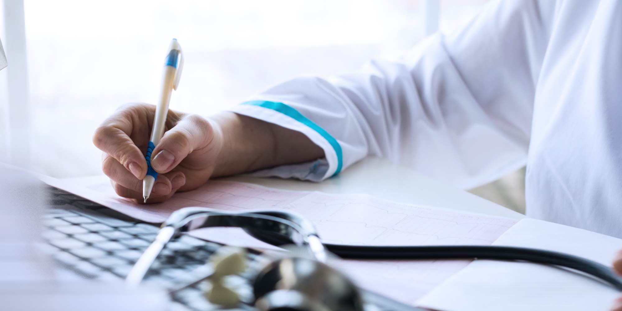 Doctor Writing Down Notes About A Medical Examination Needed To Diagnose Alcohol Abuse