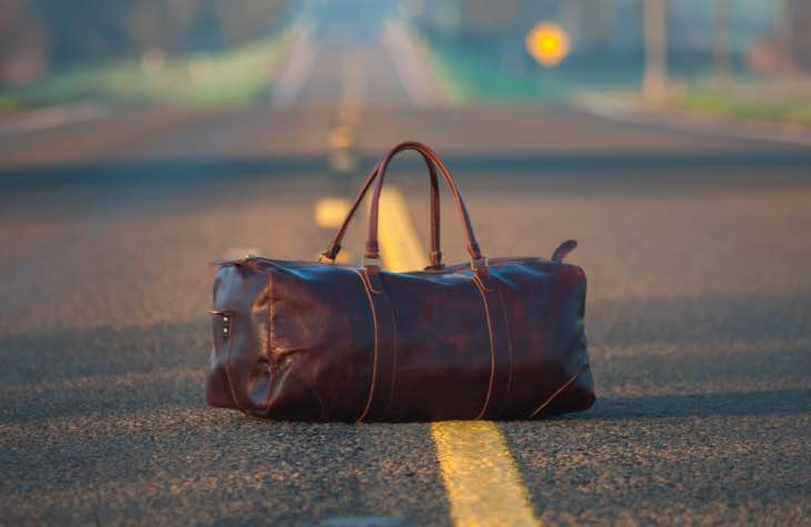 Bag In The Road To Symbolize Traveling For Alcohol Rehab