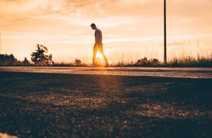 Man Walking On Dirt Path Experiencing The Symptoms Of Alcoholism