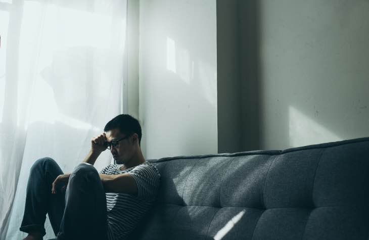 Person Struggling In A Dark Room To Deal With Mental Illness Alongside Their Alcohol Addiction