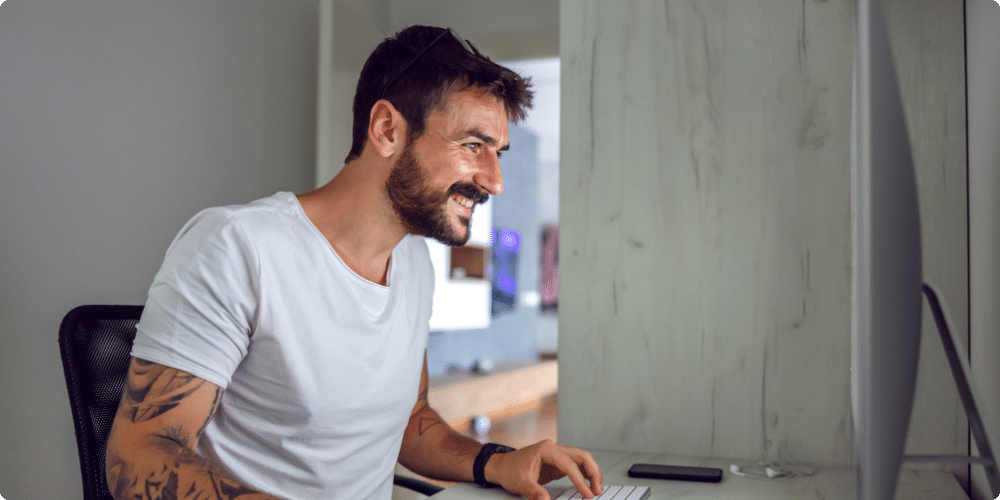 man working on computer during drug and alcohol rehab at the hope house as part of the executive treatment program