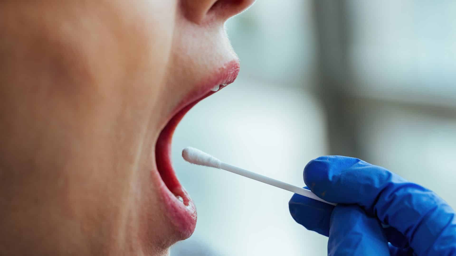 doctor doing saliva test to see how long does marijuana stay in your system