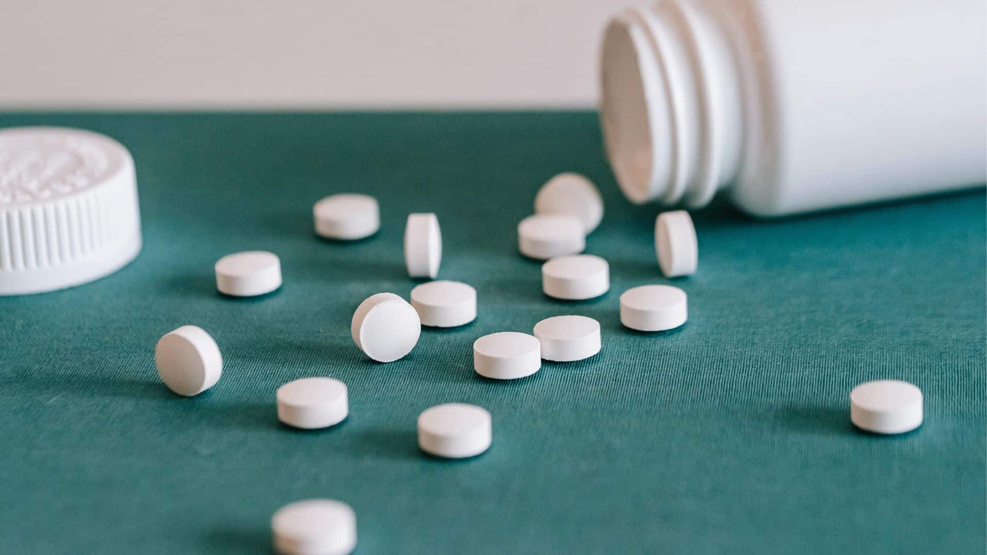 Opioids spilled out of white jar