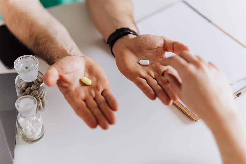 Photo Depicting Medical Professional Handing Medicine