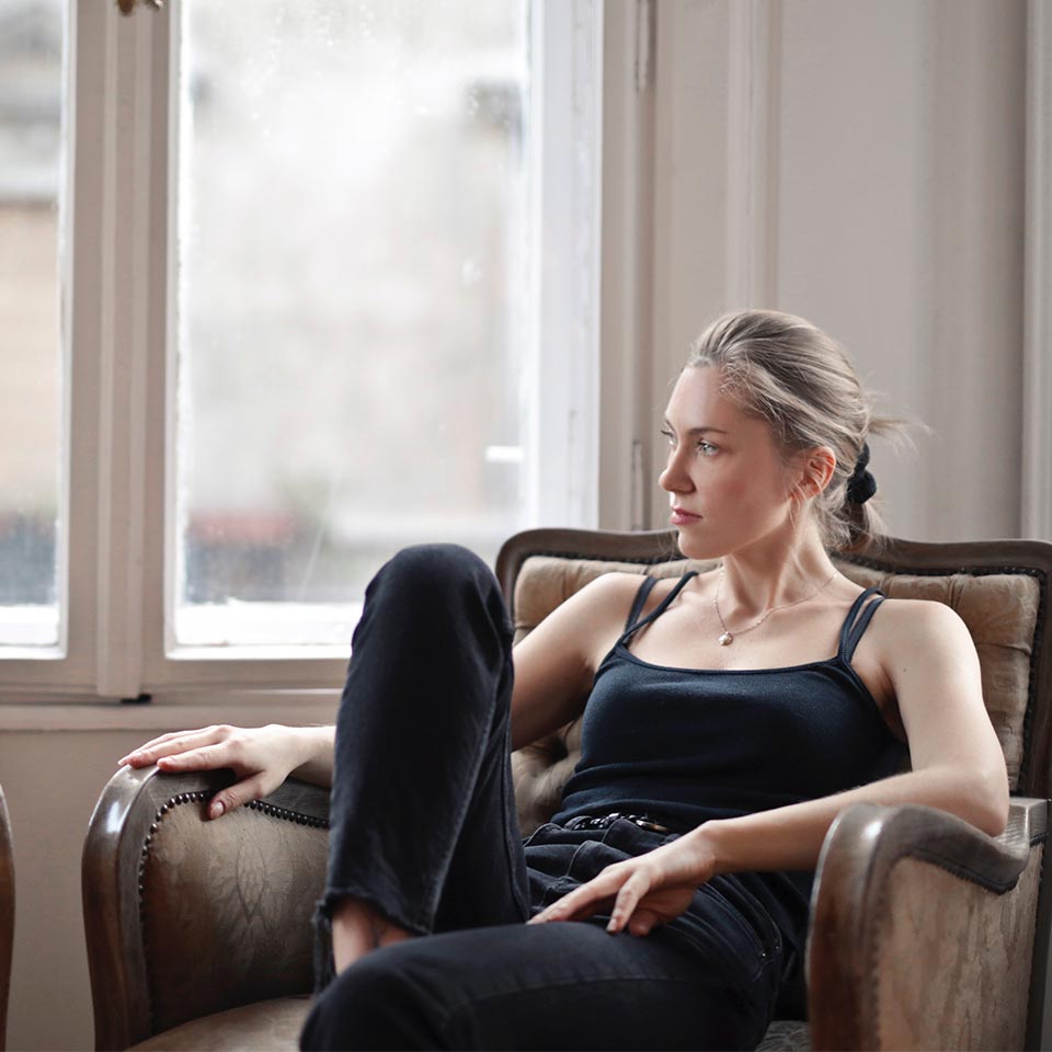 Photo Of Woman Sitting On A Couch