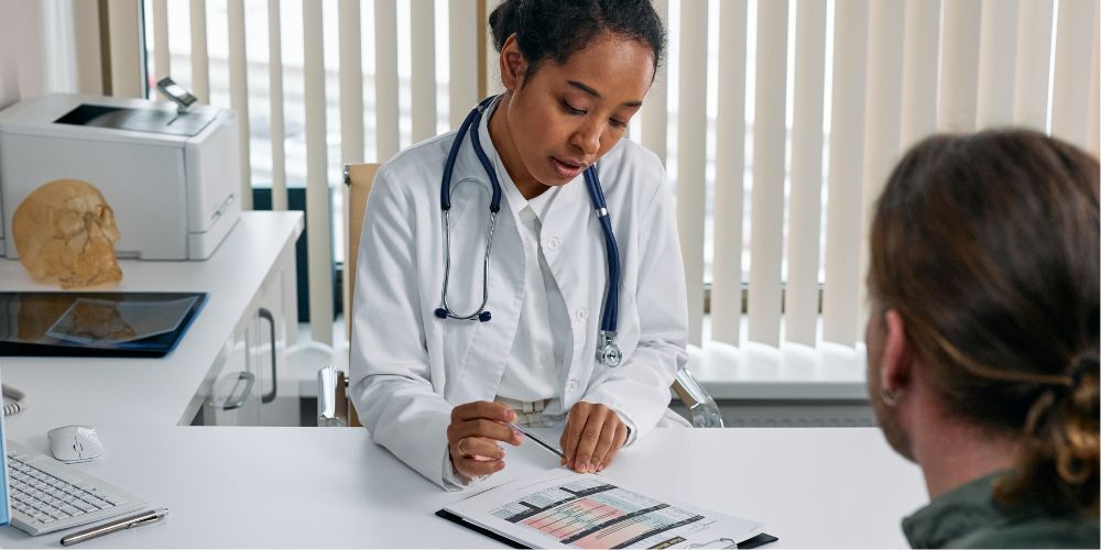 Photo Showing A Medical Staff Monitoring The Progress Of Patient