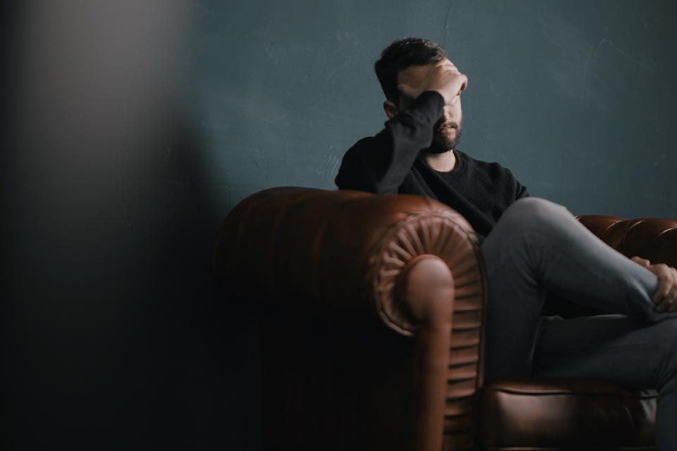 Photo Showing A Patient Sitting In A Couch Inside Therapy Room