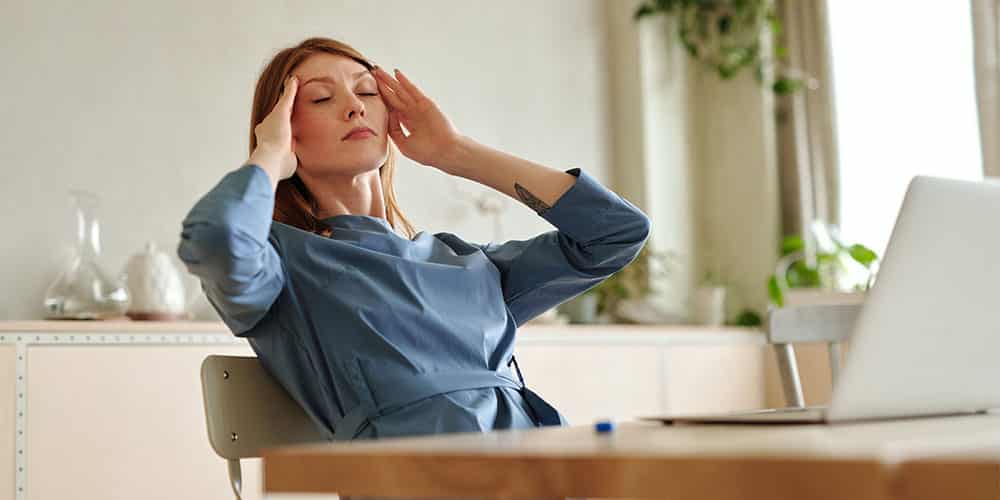 photo of woman experiencing headache