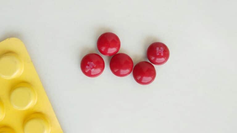 red round pills on white table