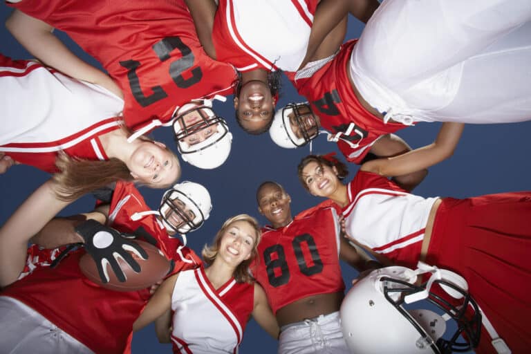 football players in huddle