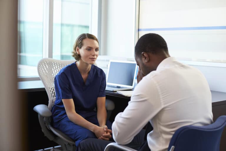 nurse consulting male patient