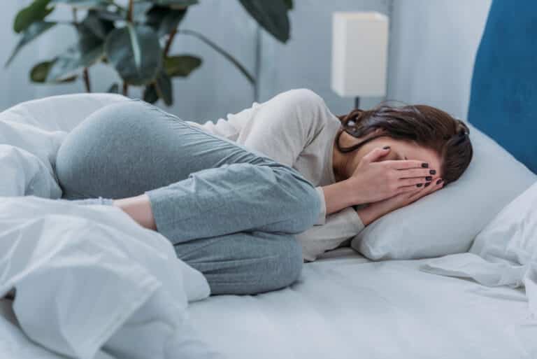 woman lying bed crying