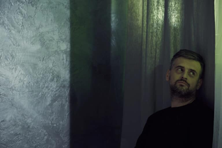 man leans on wall