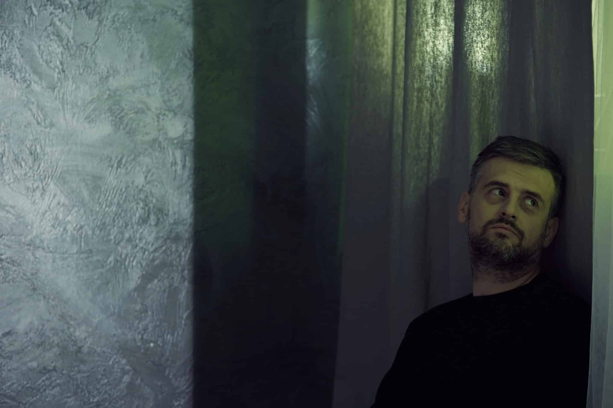man leans on wall