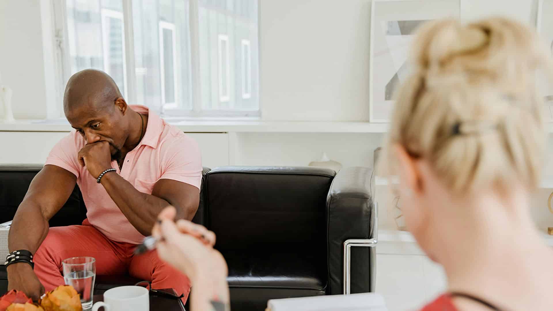 man sits on a couch undergoing therapy
