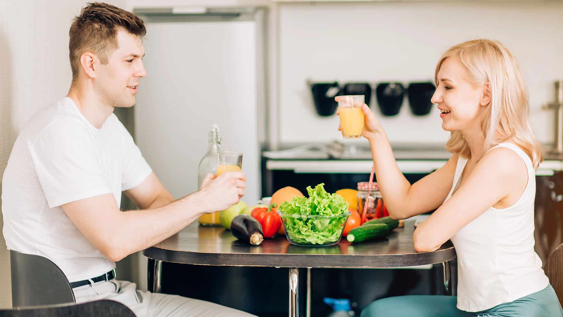 Happy couple eating breakfast together