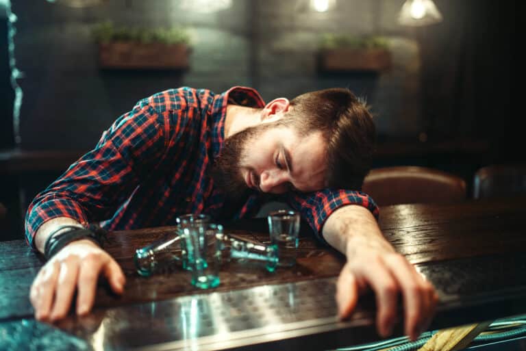 man pass out bar counter