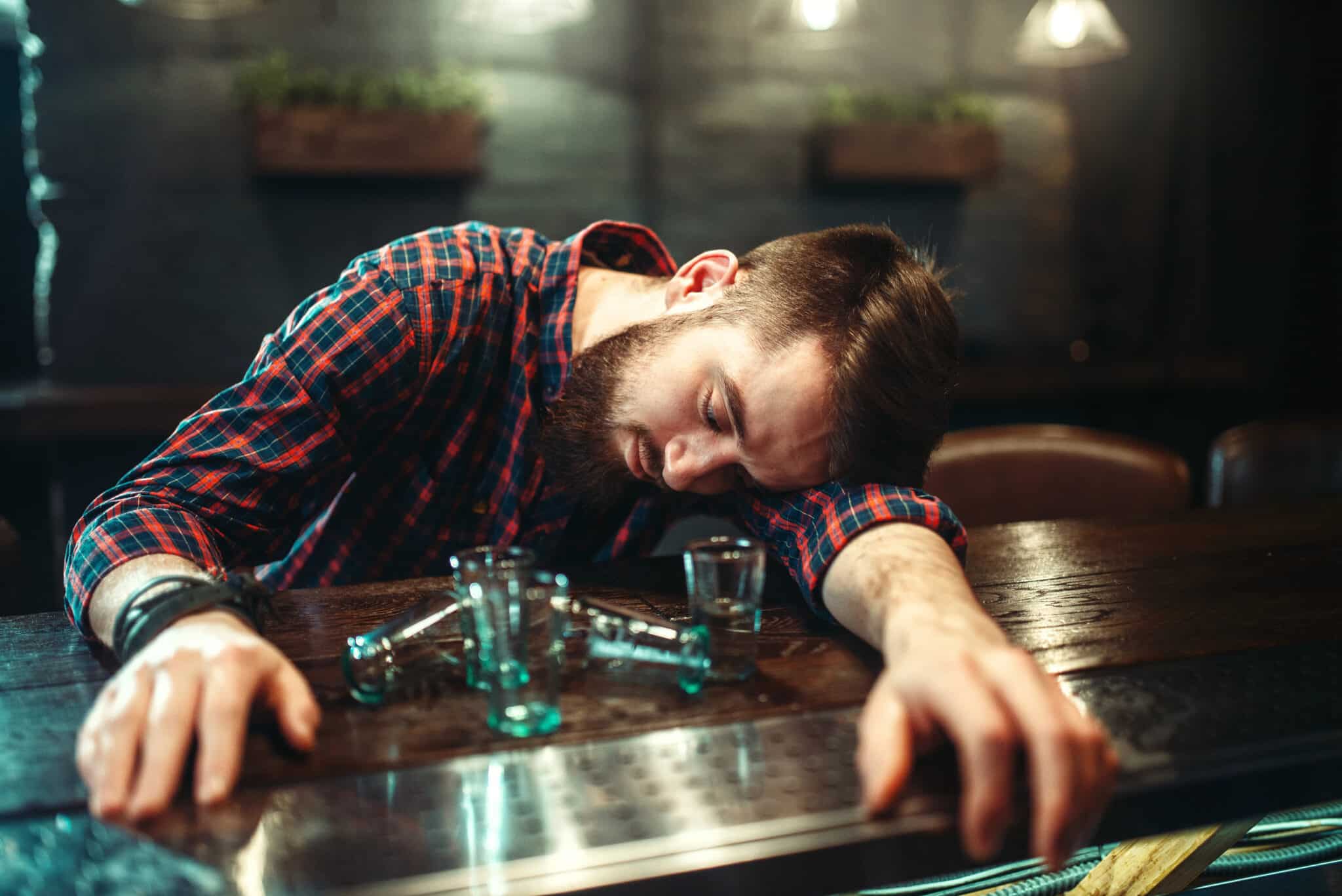 man pass out bar counter