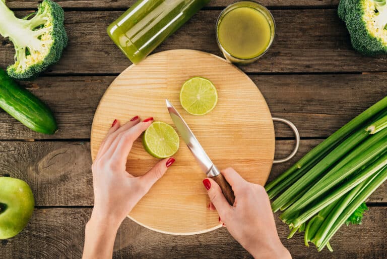 woman cutting lime for detox