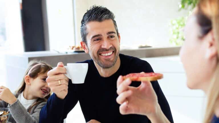 happy couple having breakfast in family