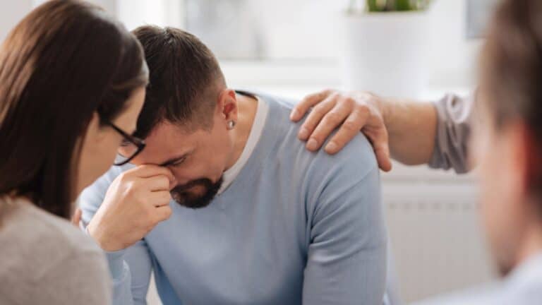 Disappointed man bowing his head