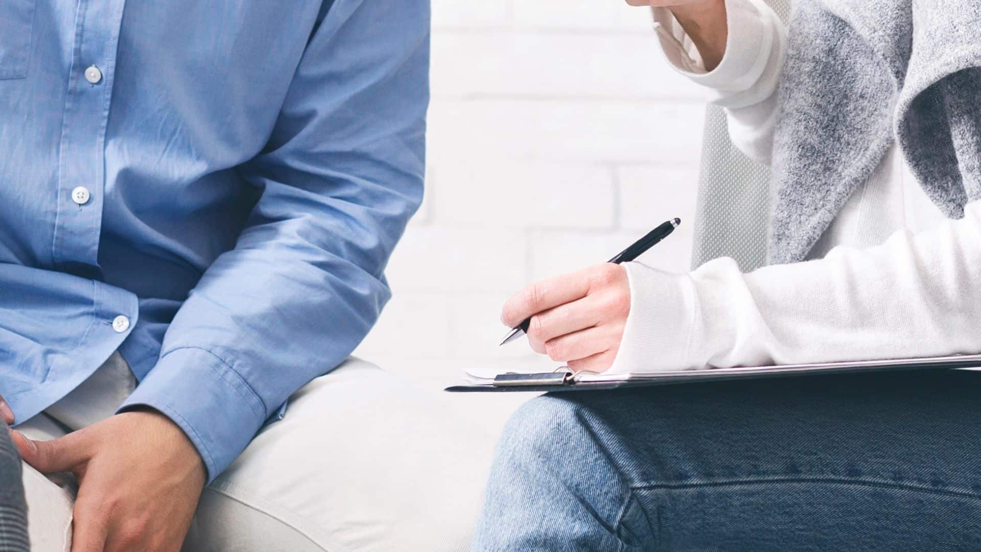 people discussing their problems with psychologist at group therapy session
