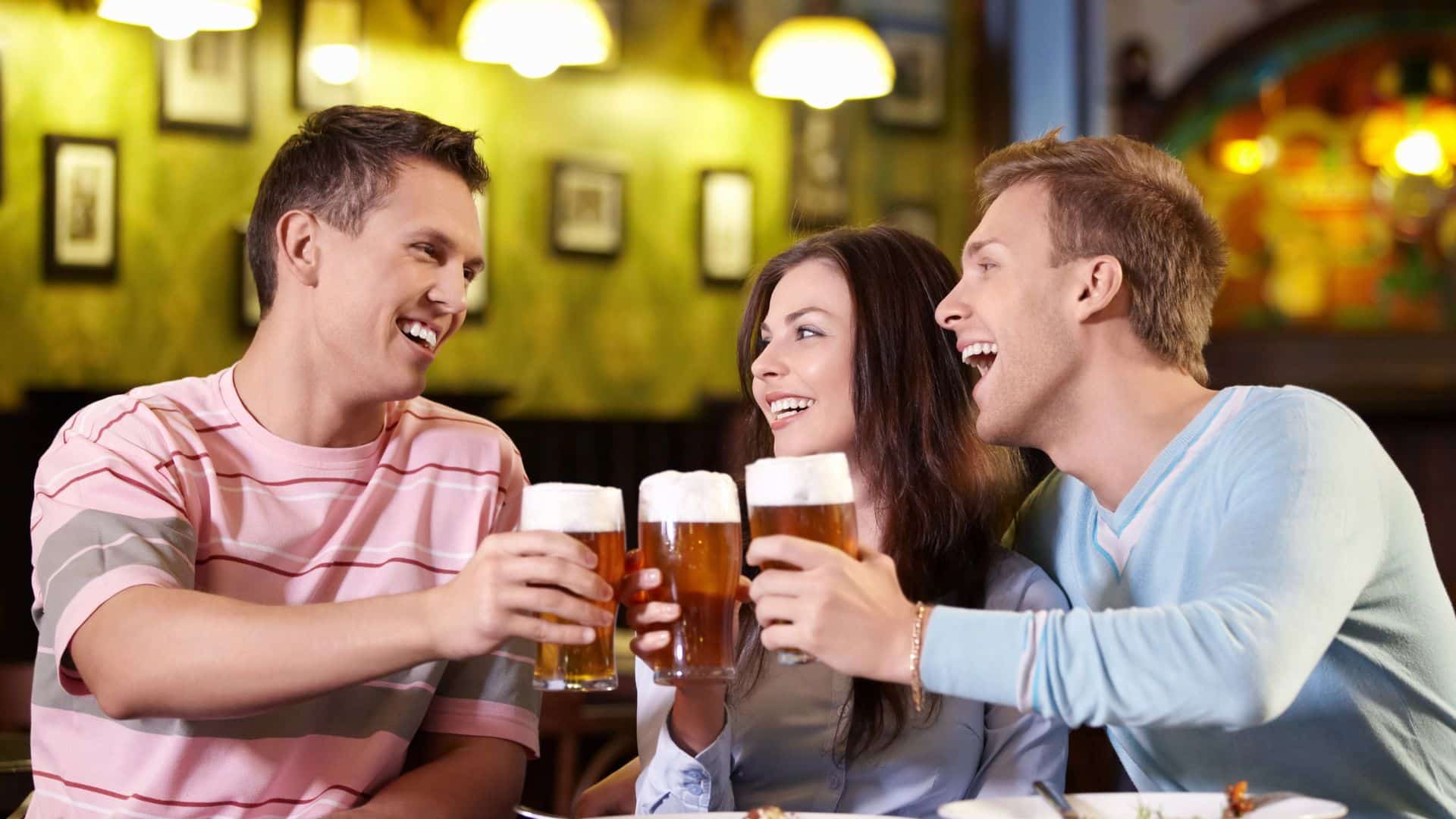 young adult in a bar having beer