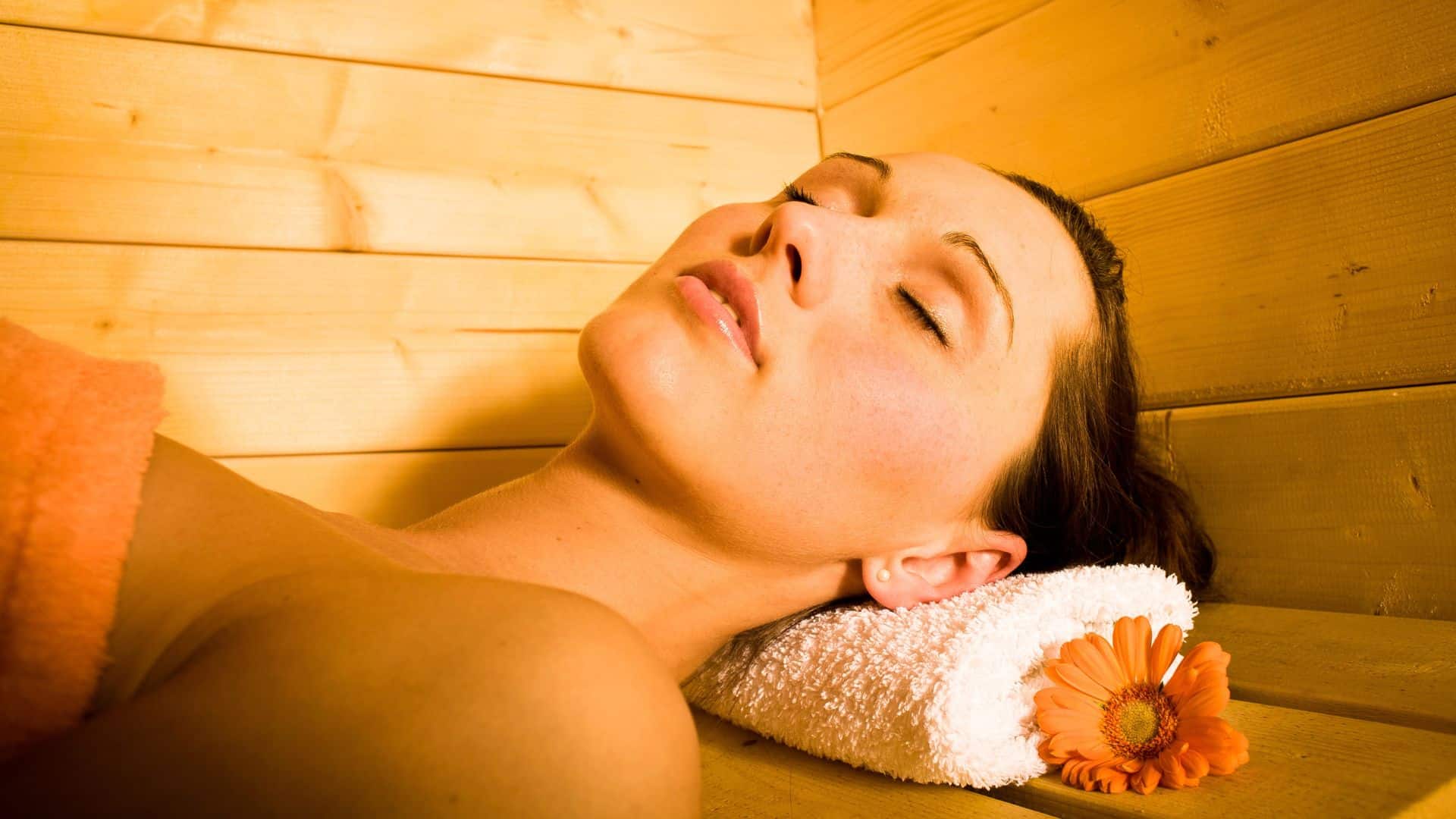A woman relaxes in a sauna
