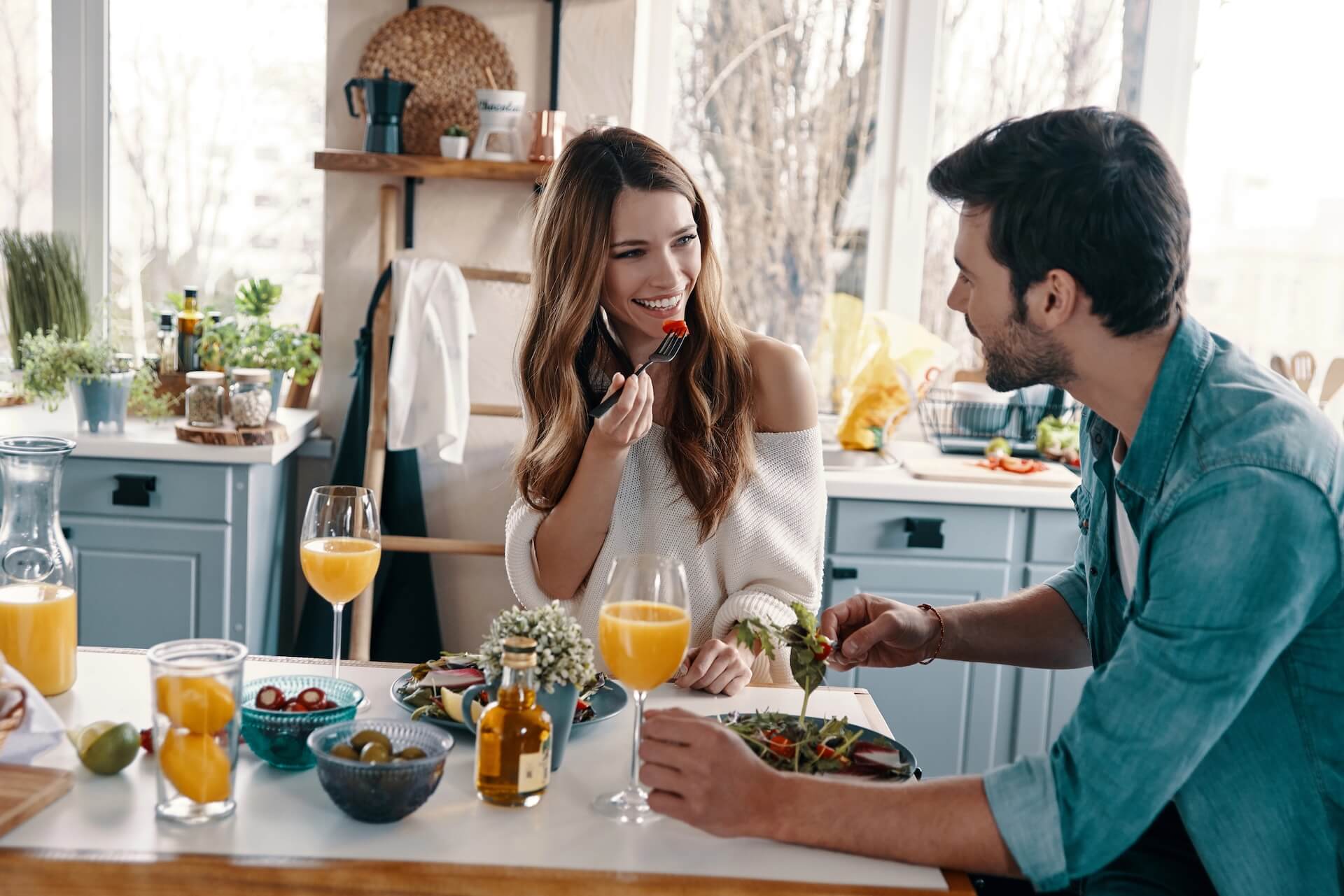 Beautiful young couple enjoying healthy breakfast