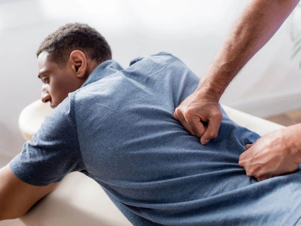 Chiropractor working with young and injured patient