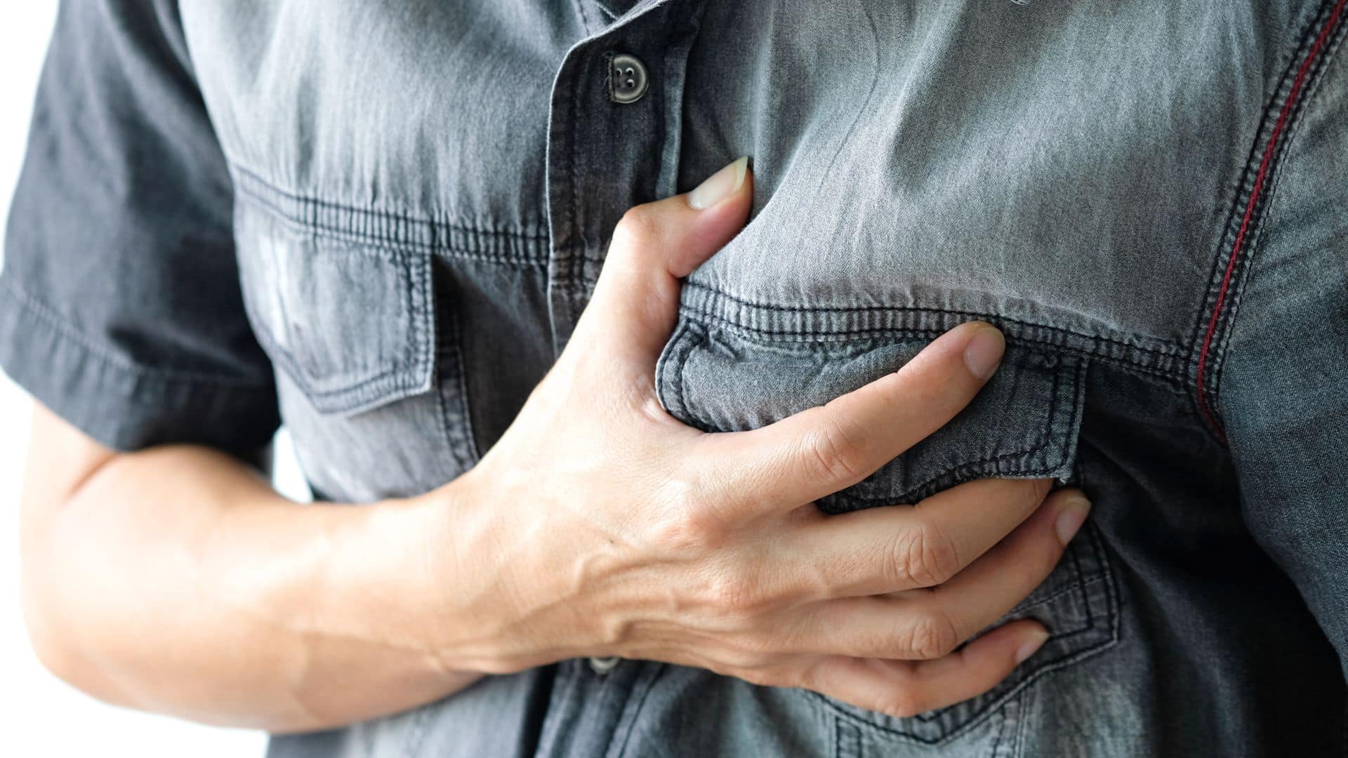 Man standing chest pain in the bedroom