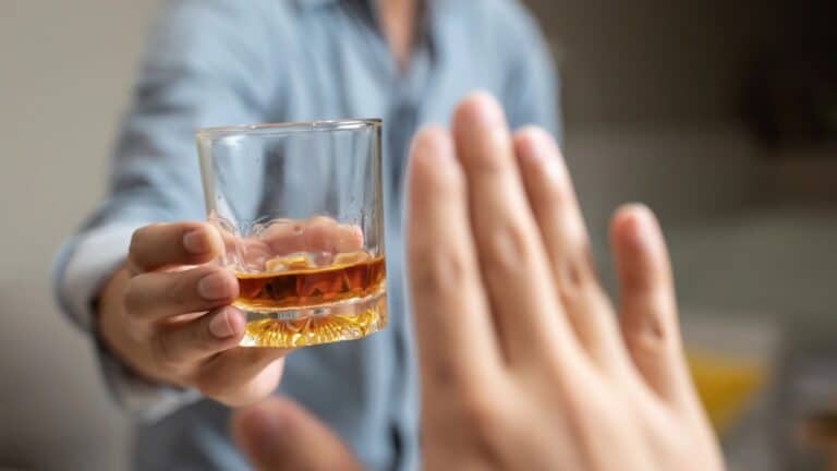 Person deny alcohol drink from his friend