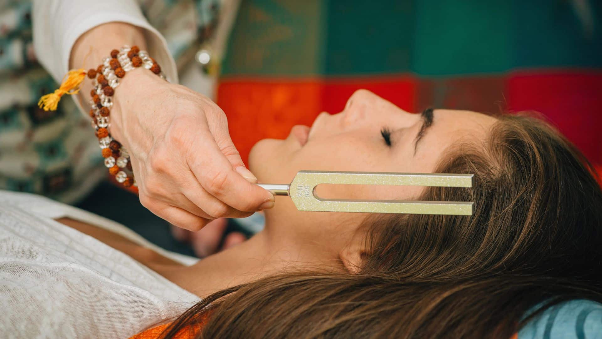 Woman using Tuning fork in sound therapy