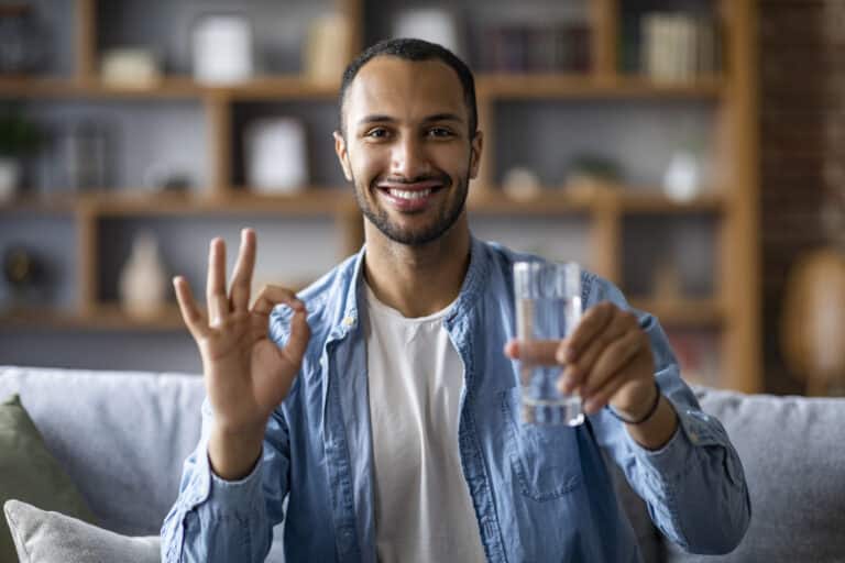cheerful handsome black guy holding glass of water 2025 03 18 18 11 08 utc