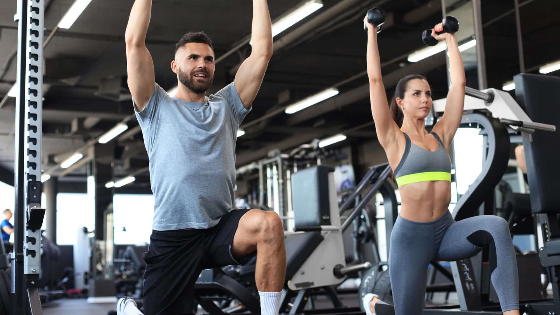 people are working out with dumbbells at gym