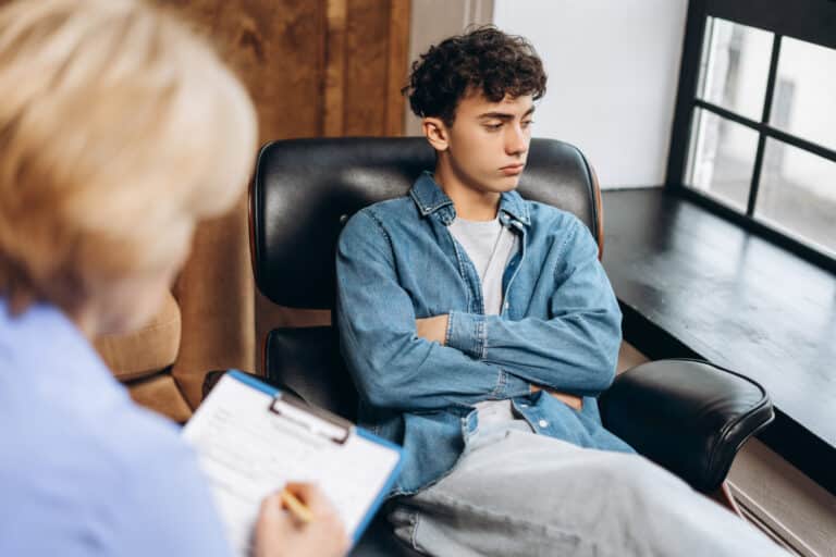 teenage boy with crossed hands sitting on a sofa a 2025 08 26 07 48 32 utc