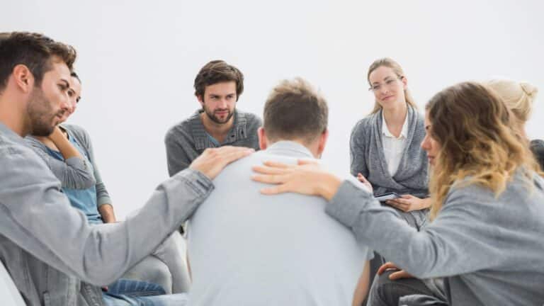 Group therapy in session sitting in a circle