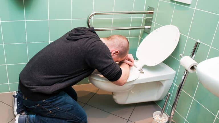 Man vomiting in the toilet
