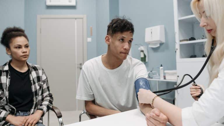 A doctor checks a patient's blood pressure